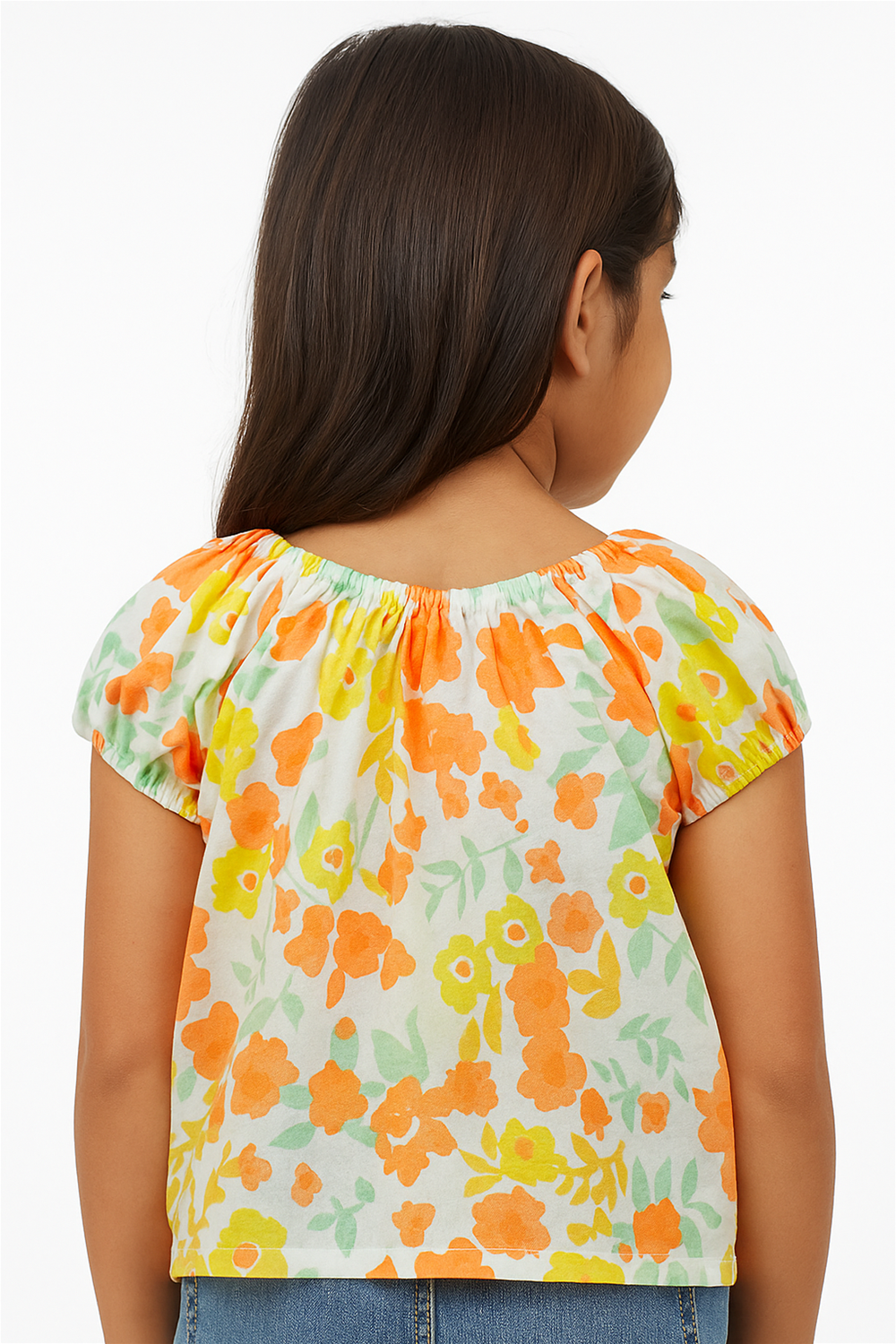 Rear view of a young girl wearing a colorful floral printed top with puff sleeves, paired with casual denim jeans.