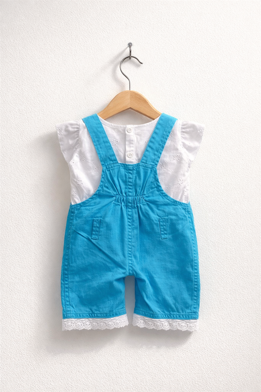 Sky Blue baby dungaree with white inner top, elasticated back waist, lace-trim hem, neatly displayed on wooden hanger