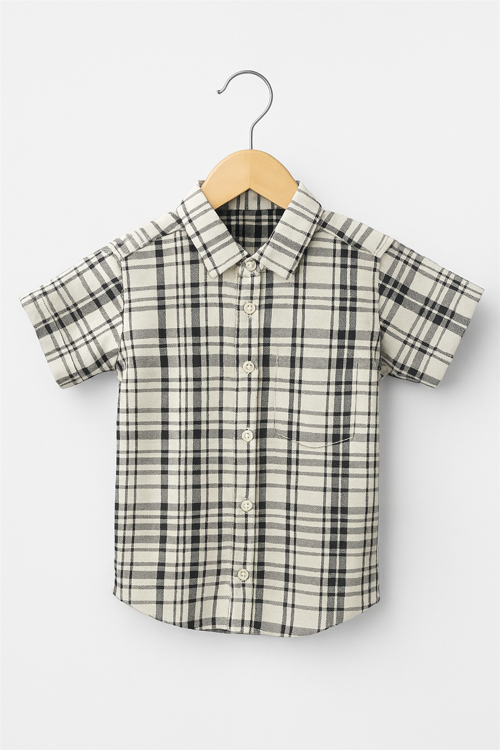 A boy's half-sleeve shirt featuring a classic black and white check pattern with a normal collar.
