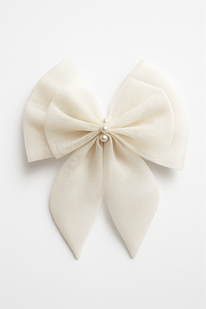 Elegant cream hair bow with flowing tails, adorned with three pearl beads at center, displayed on white background for clarity.