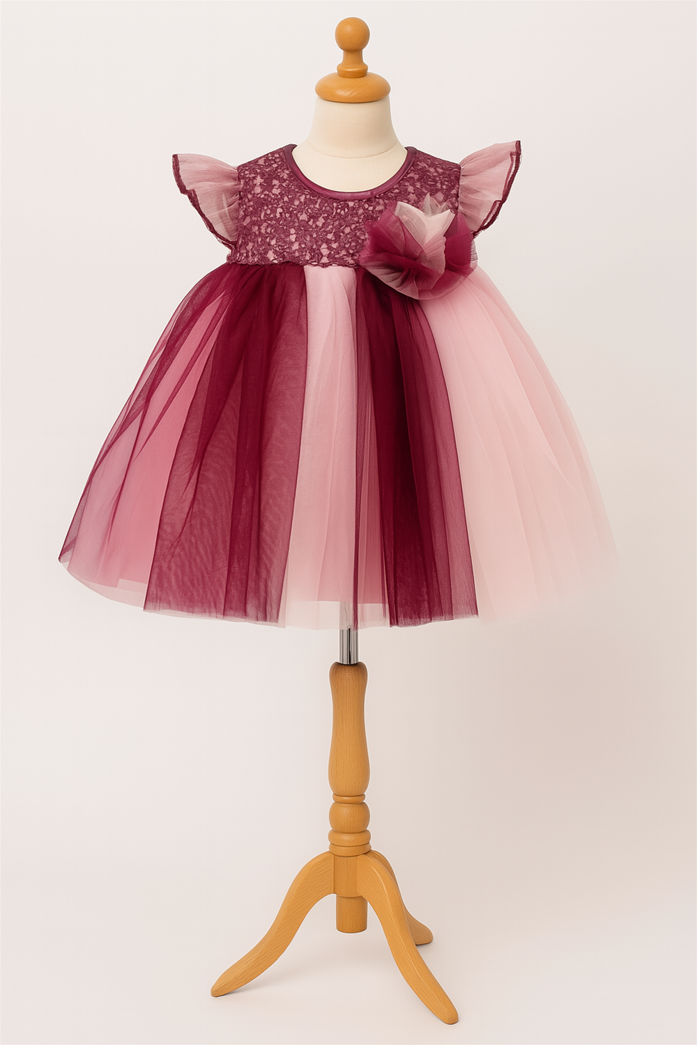Baby girl's dress featuring a multi-color net skirt in pink and Purple with an alter neck design.