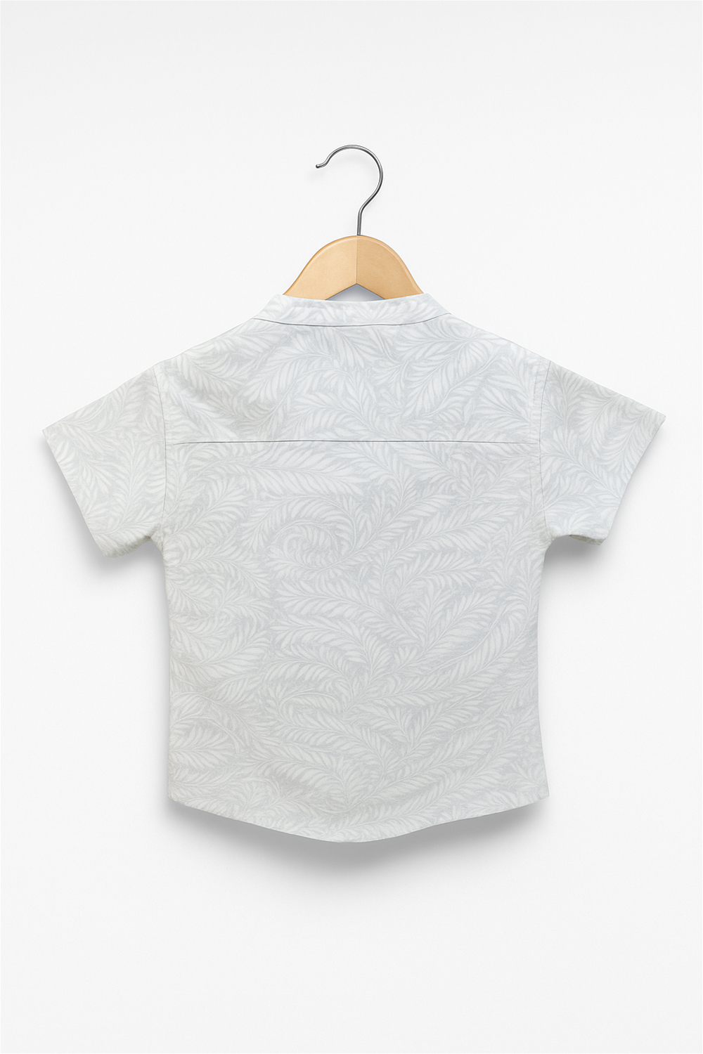 Back view of a boys' half sleeves Chinese collar shirt in soft pastel grey, featuring a subtle leafy print. Shirt is neatly displayed on a wooden hanger against a plain white studio background.