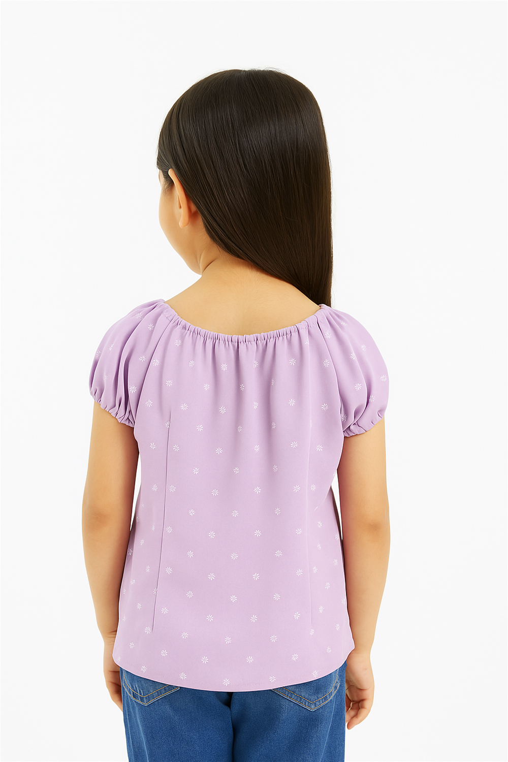Back view of lavender puff sleeve girls’ top, elastic neckline and scattered white embroidered motifs, worn by a child with jeans.