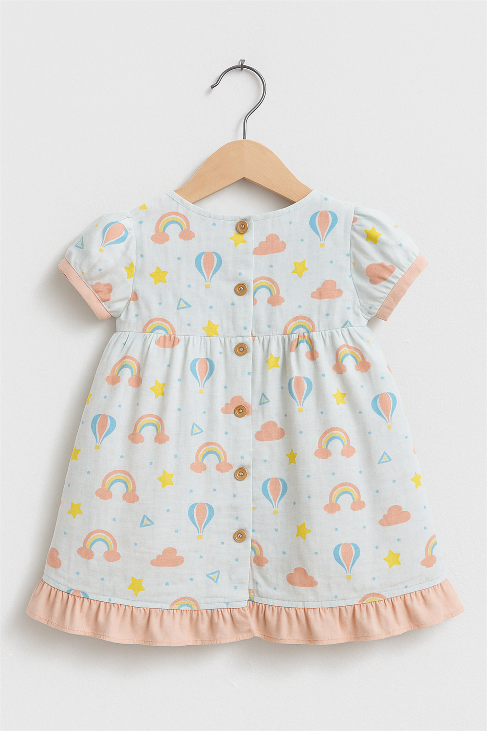 Back view of sleeveless baby dress with lace collar, button-down closure, soft beige floral print, displayed on wooden hanger.
