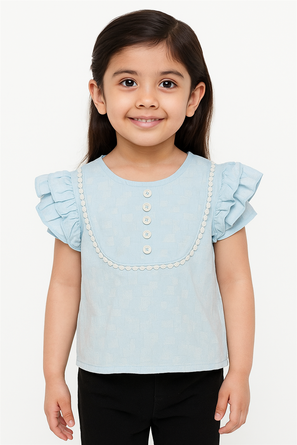 Smiling girl modeling light blue ruffle-sleeve top with lace-trimmed front and button details, paired with black pants, clean backdrop.