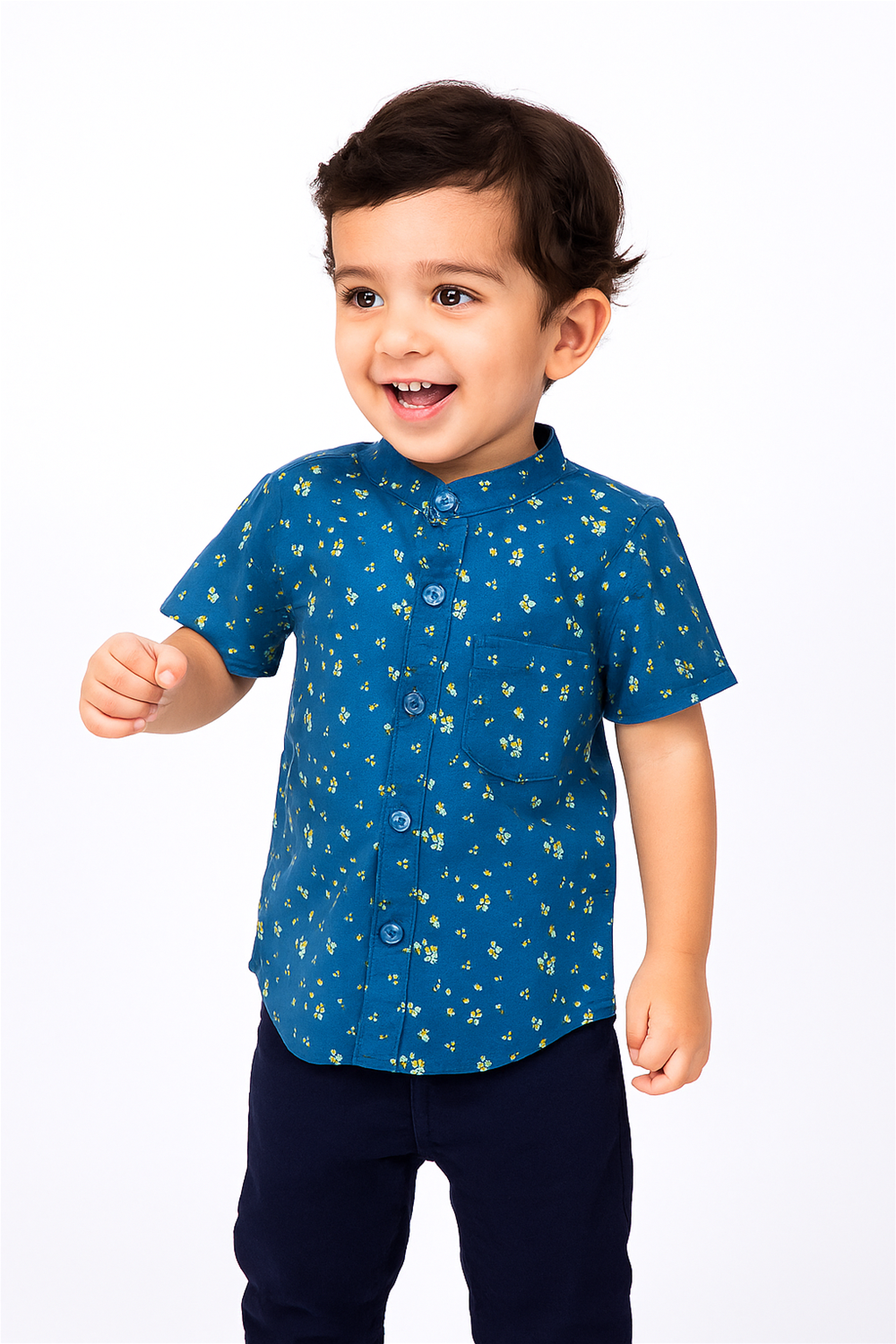 A cheerful toddler boy wearing a half-sleeve Chinese collar shirt in navy blue with a delicate yellow floral print. The shirt features front buttons and a chest pocket, paired with dark navy pants, set against a clean white background.