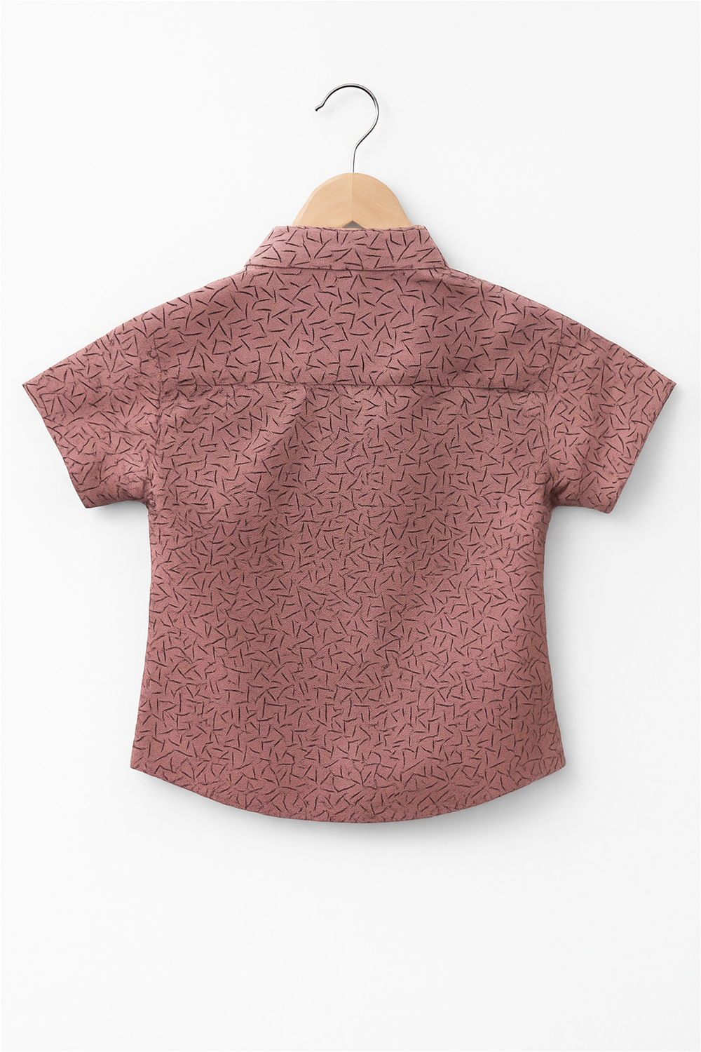 A boy's shirt featuring a vibrant dull pink floral print on a light background.