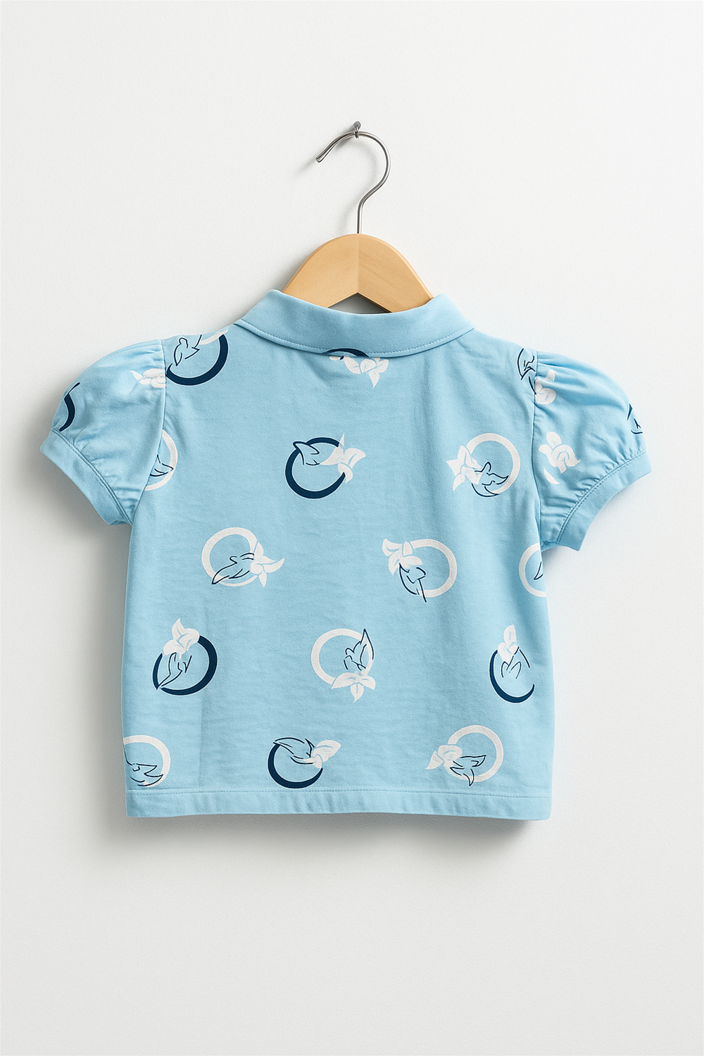 Back view of light blue Chinese collar girls’ top on hanger, puff sleeves, printed bird-in-circle motifs, clean studio background.