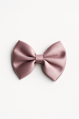 A standalone pink satin bow hair clip placed against a white background, showing its neatly folded design and gentle sheen