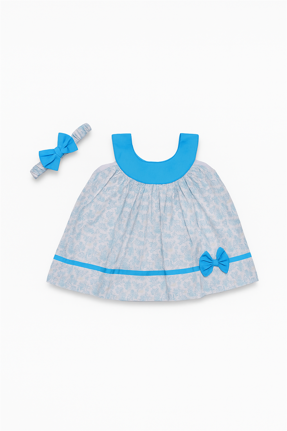 Flat lay of baby blue printed frock with bright blue collar and bow hairband, displayed on white background.