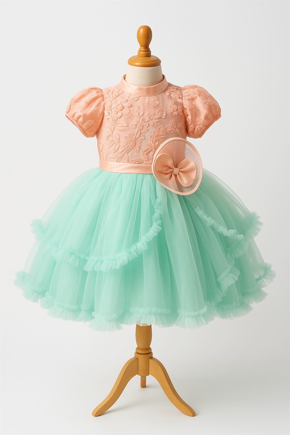 A Pista Green and Peach combination party wear dress in a foam mannequin.