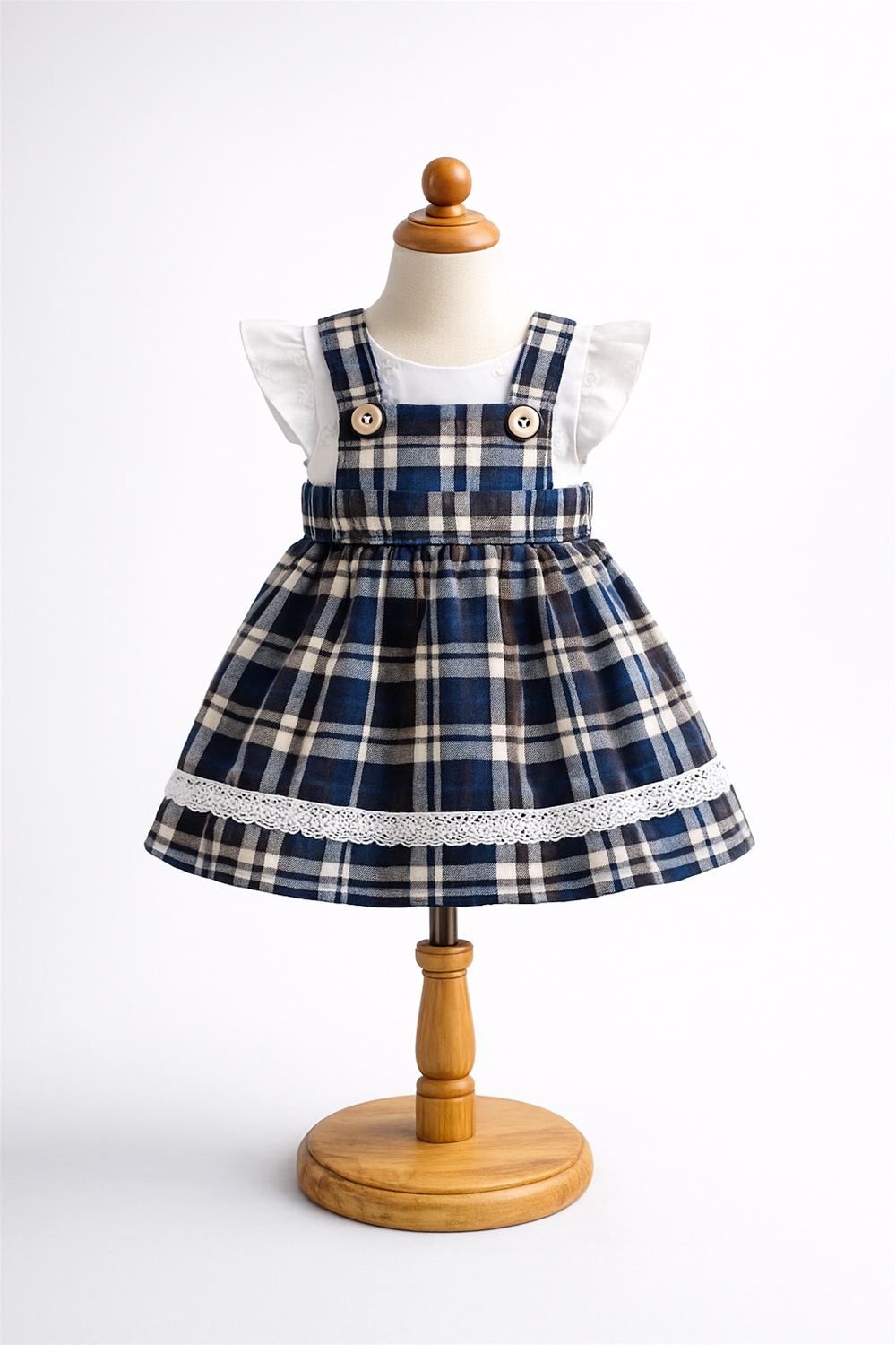 Baby girl tartan party frock displayed on mannequin, featuring Blue plaid skirt, white top, flutter sleeves, and classic festive design.