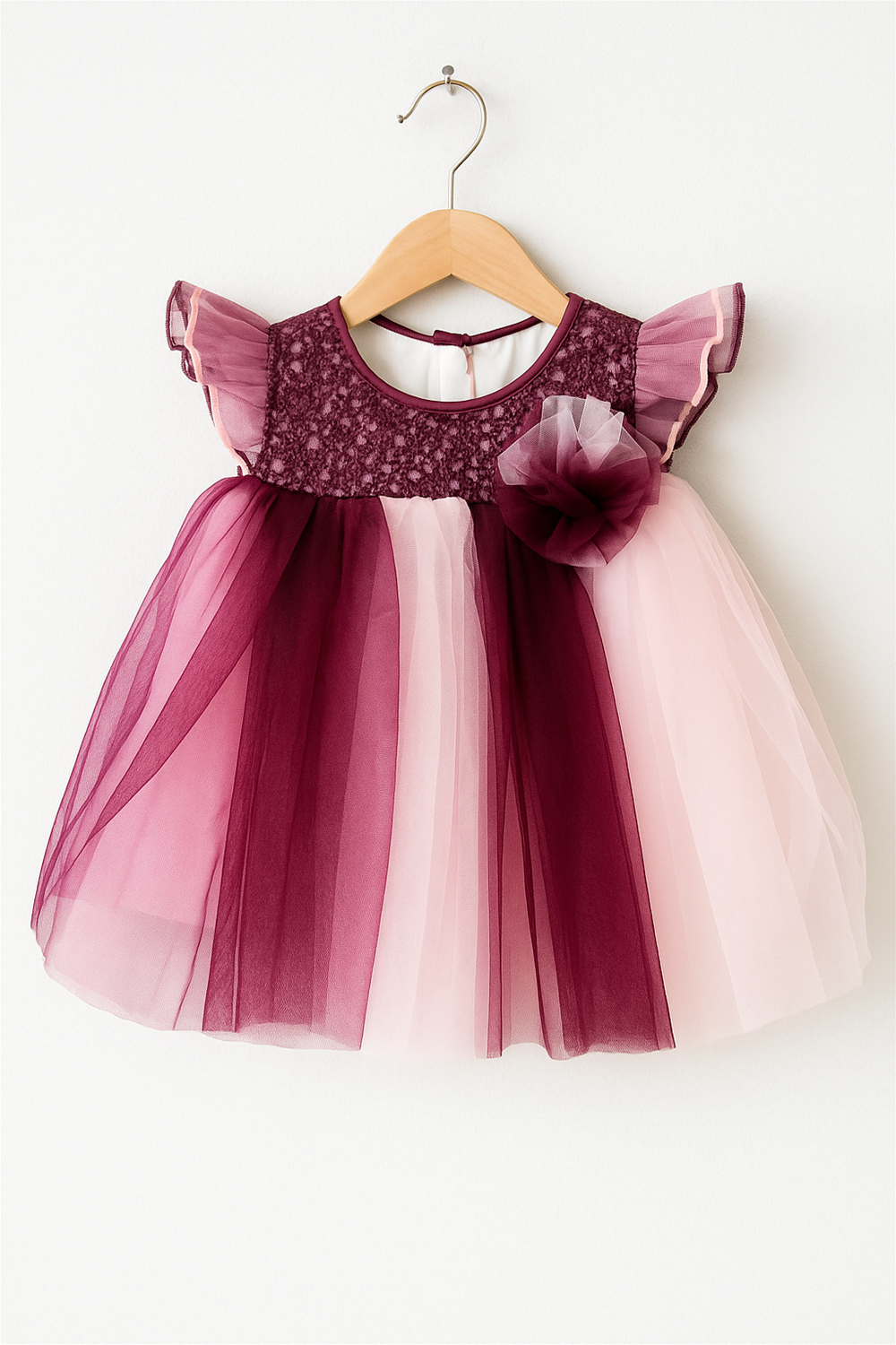 Baby girl's dress featuring a multi-color net skirt in pink and Purple with an alter neck design.