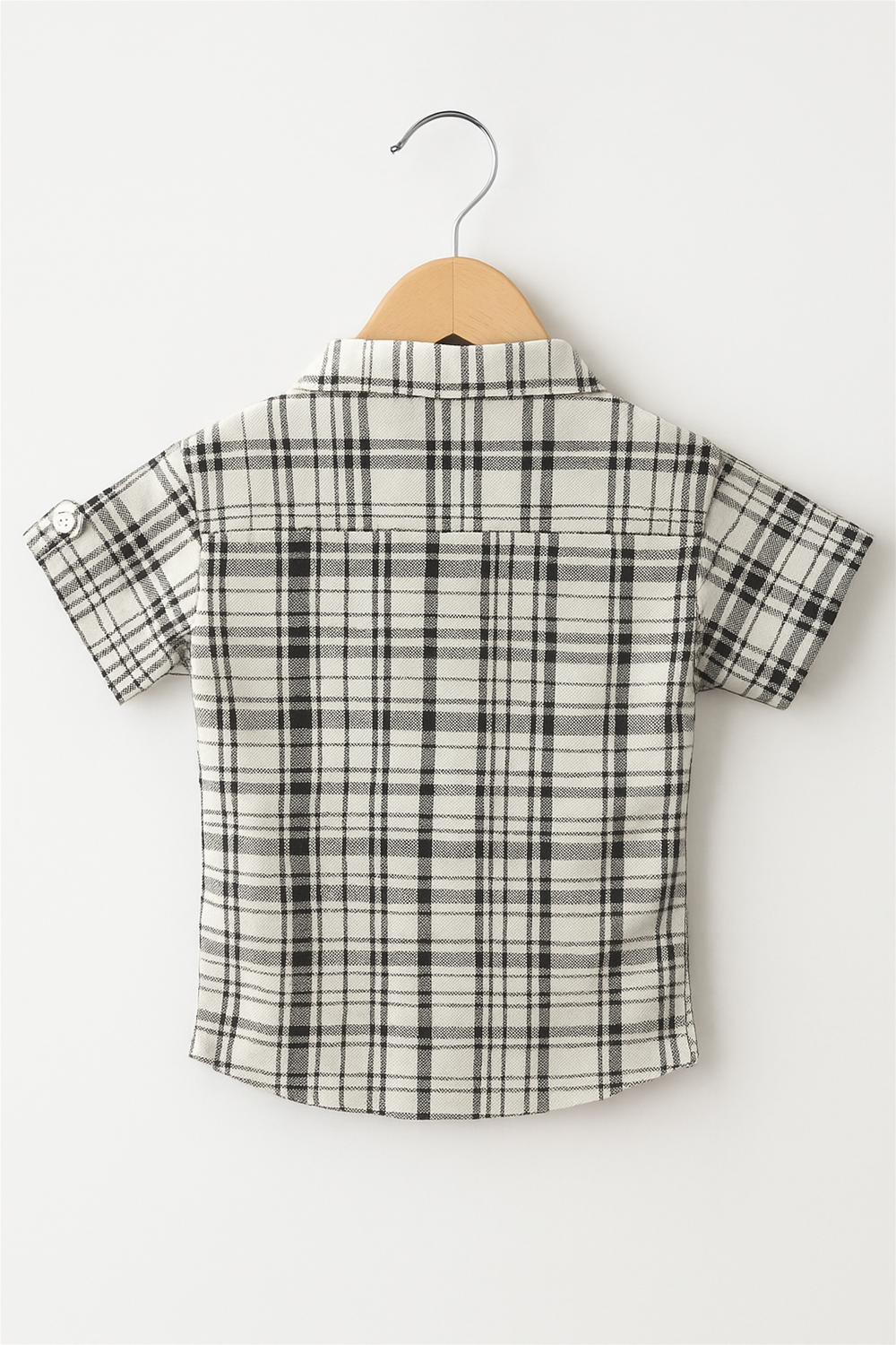 A boy's half-sleeve shirt featuring a classic black and white check pattern with a normal collar.