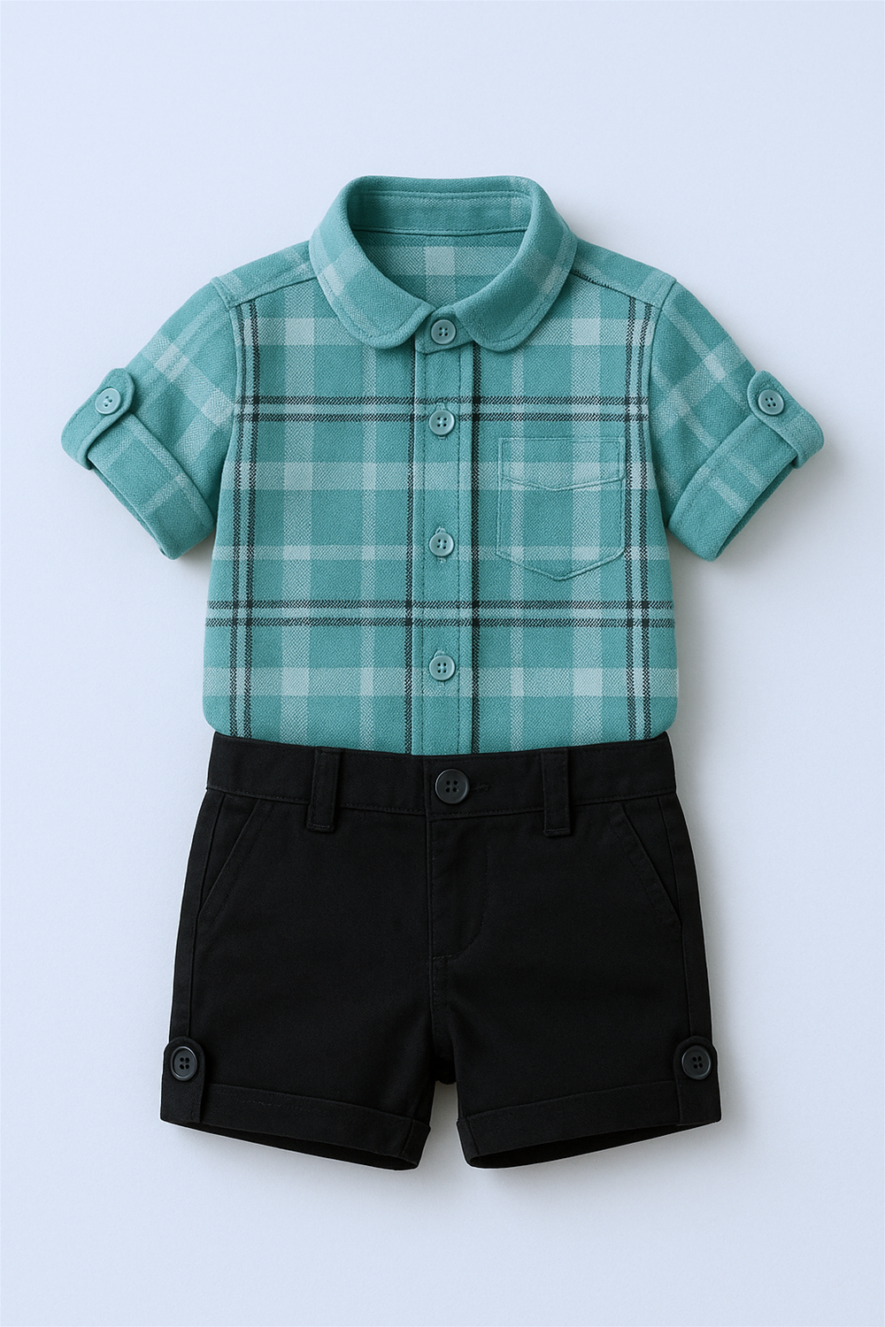 Flat lay of teal plaid short-sleeved shirt paired with black buttoned shorts, displayed neatly on neutral background.