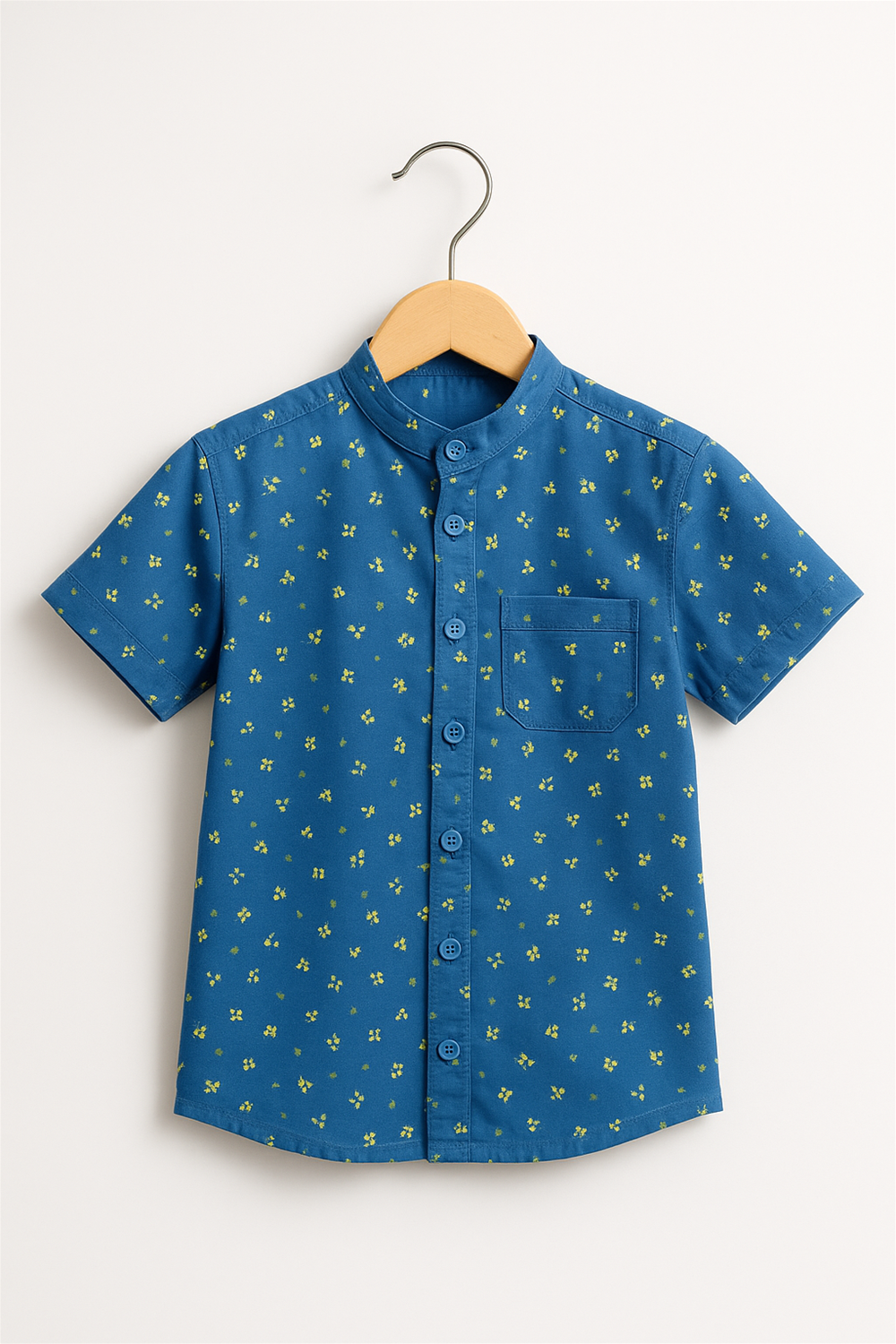 Front view of a boy's half-sleeve Chinese collar shirt in navy blue with a charming yellow floral print. Displayed neatly on a wooden hanger, this stylish shirt features a button-down front and a chest pocket.