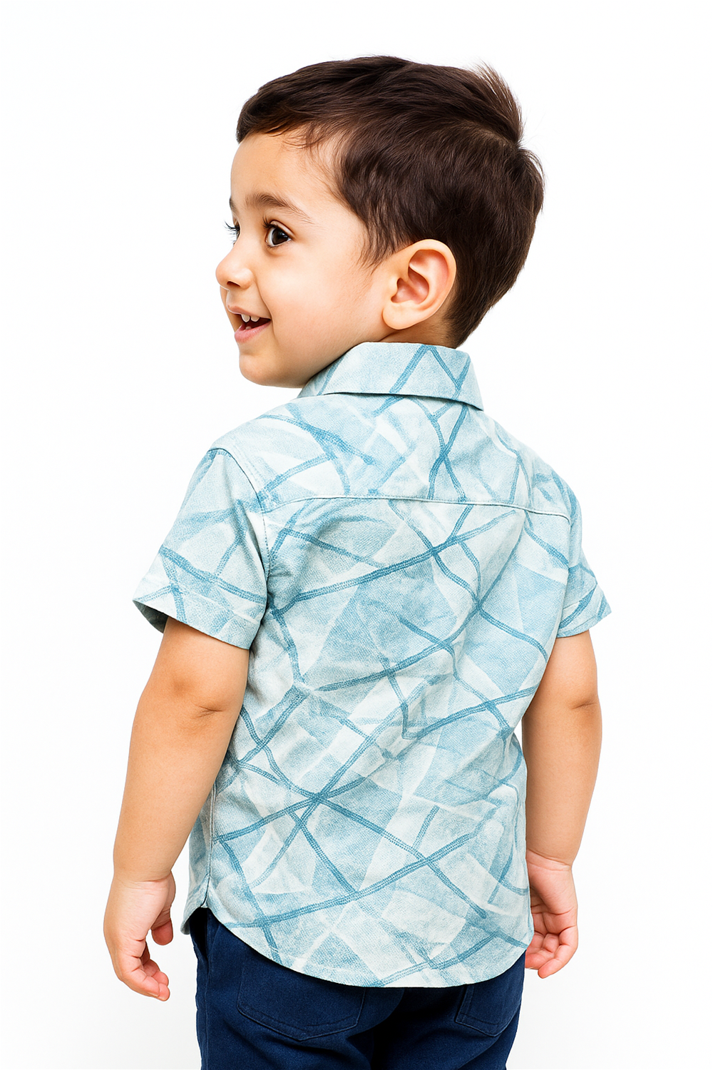 Back view of a toddler boy wearing a half-sleeve club collar shirt in a light aqua geometric pattern. The neatly tailored shirt showcases a clean yoke and curved hem, ideal for stylish everyday wear.