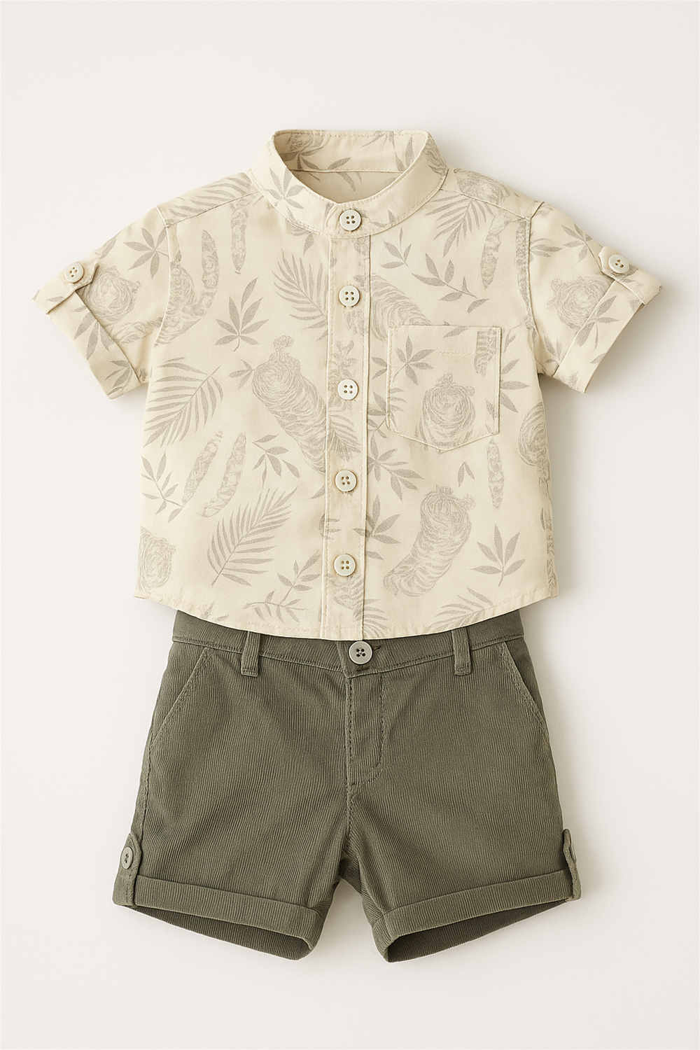 light yellow printed shirt with rolled sleeves paired with olive corduroy shorts, displayed flat against light background, front studio product shot.