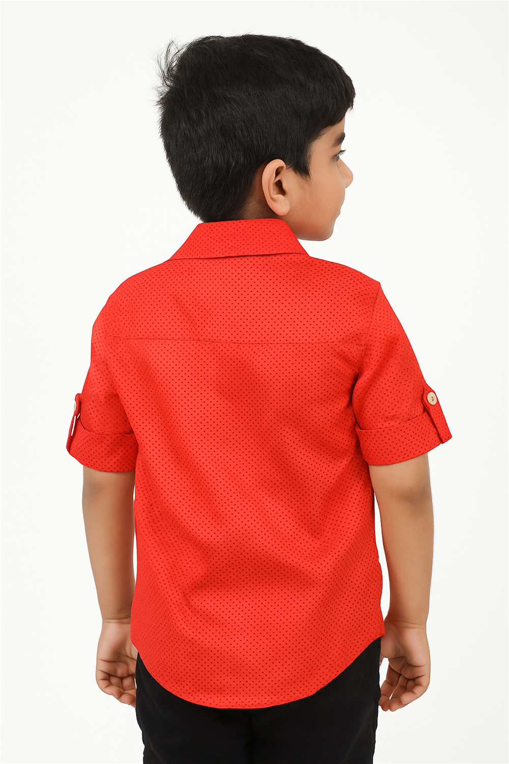 A young boy in a Red with small black polka dots half-sleeve shirt with a normal collar.