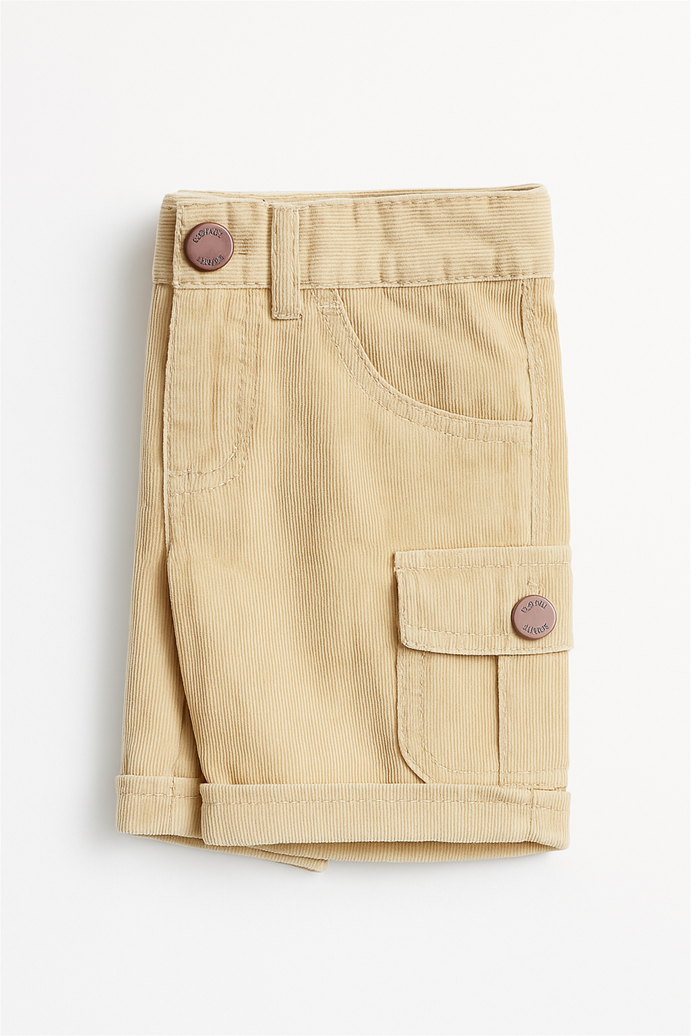Folded beige corduroy boys' cargo shorts displayed on a white background. The shorts feature a front pocket, a side flap cargo pocket with a button closure, visible belt loops, and neatly turned-up hems.