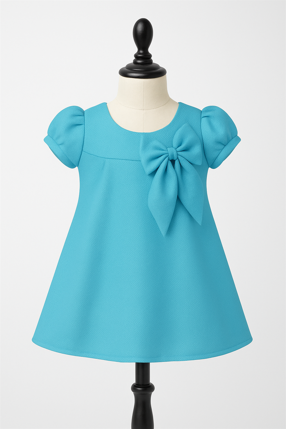 A baby blue dress featuring a prominent bow on the front, showcasing a charming and playful design.