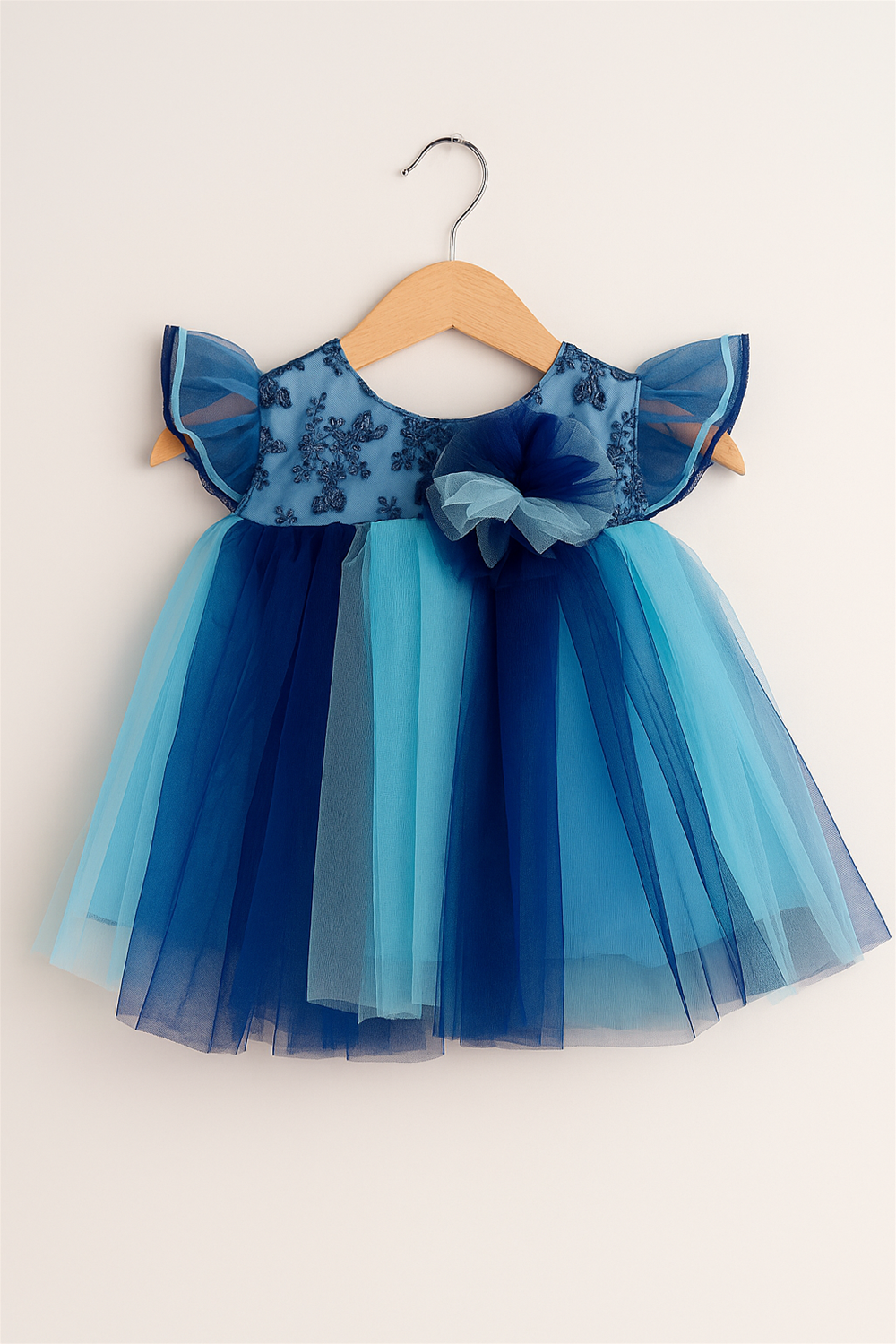 Baby girl's dress featuring a multi-color net skirt in  Light blue and Peacock blue with an alter neck design.