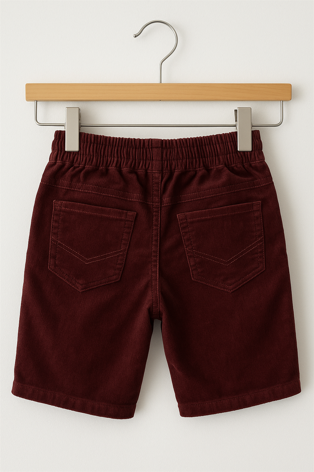 Bright Maroon Corduroy with box side pockets and buttons., Ideal for casual wear. In wooden hanger back view.
