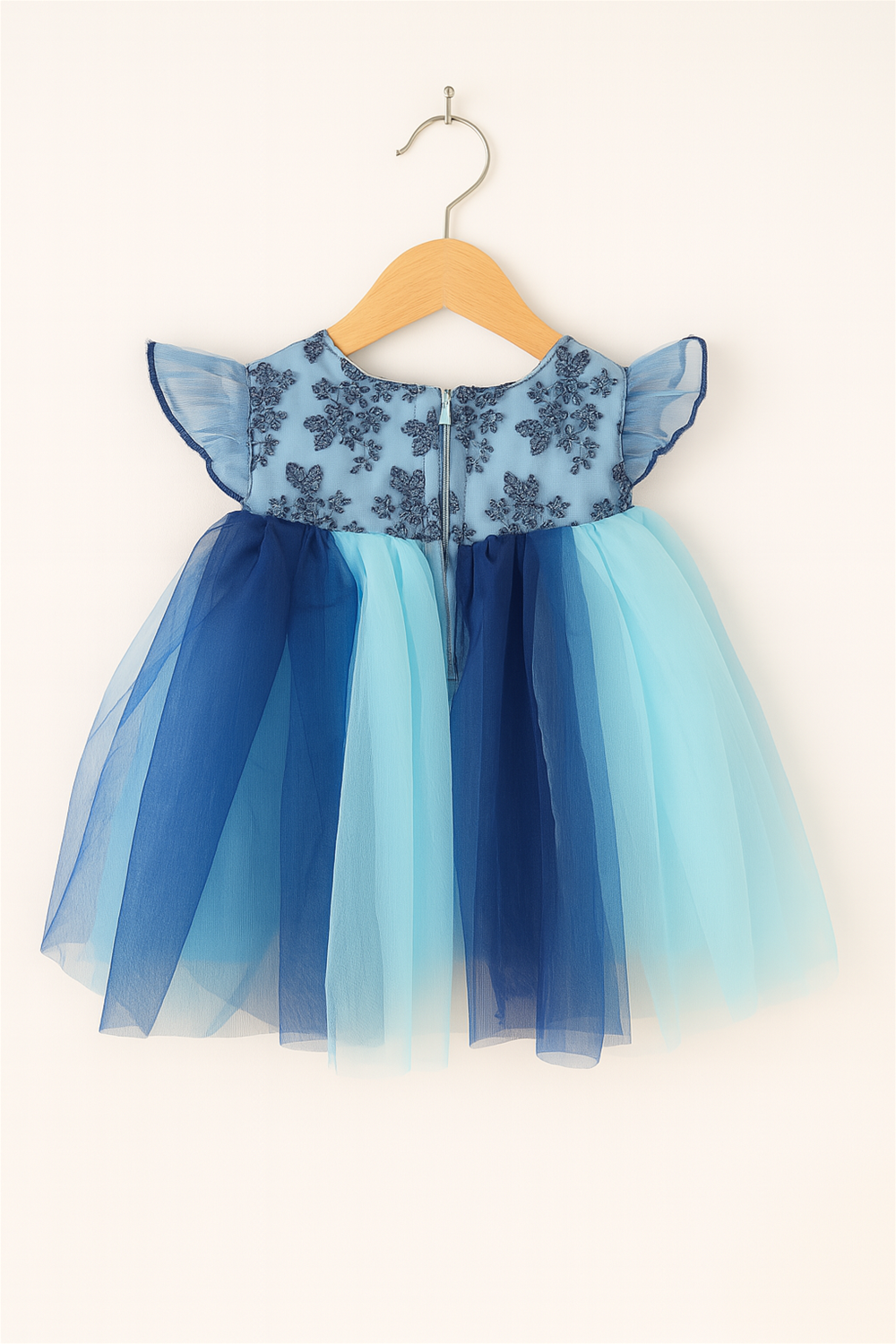 Baby girl's dress featuring a multi-color net skirt in  Light blue and Peacock blue with an alter neck design with back zip closure