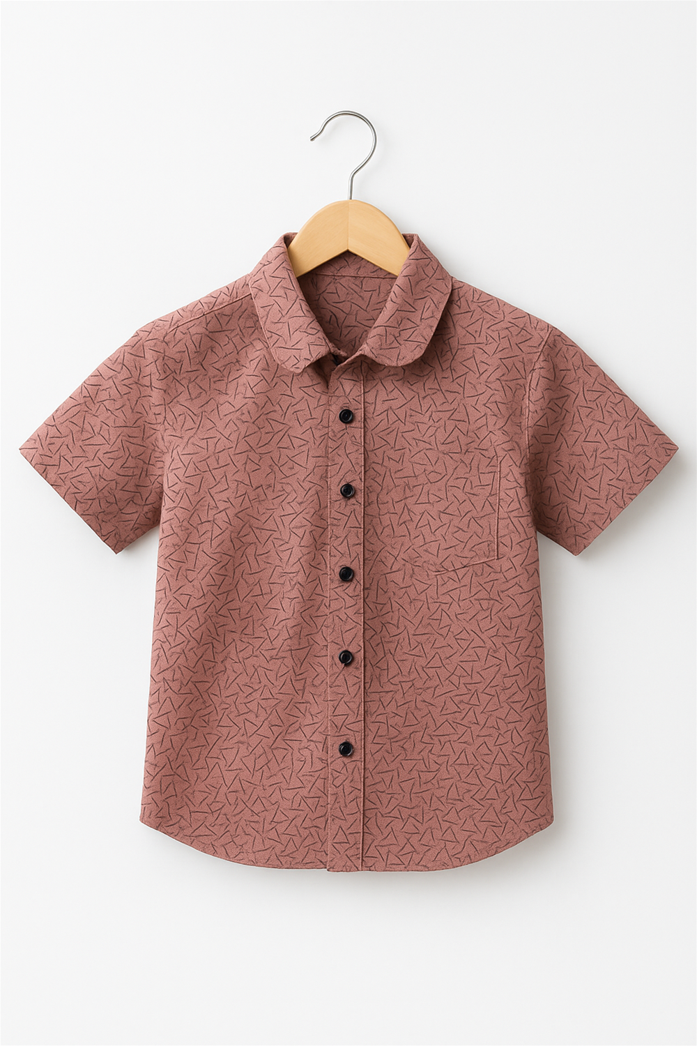 A boy's shirt featuring a vibrant dull pink floral print on a light background.
