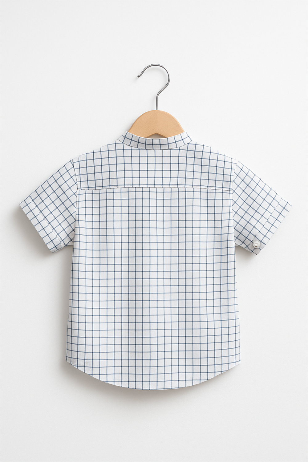 White checkered short-sleeve shirt displayed on wooden hanger, clean studio background, highlighting grid pattern and straight hemline.