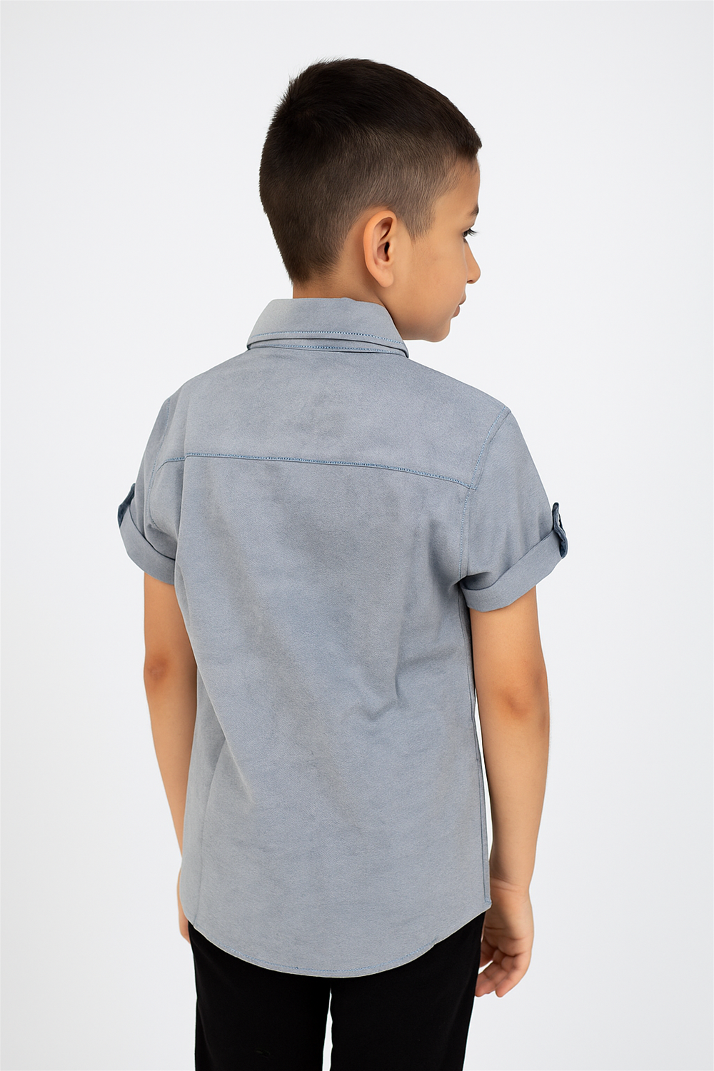 A young boy in a blue half-sleeve shirt with a normal collar.