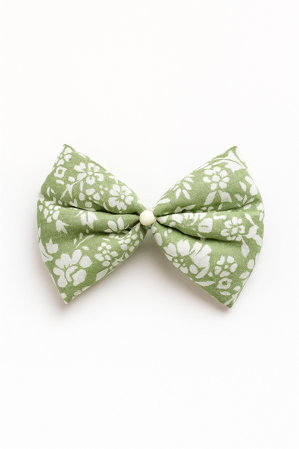 Green floral fabric bow with white flower prints and pearl center, displayed on plain white background for product presentation.